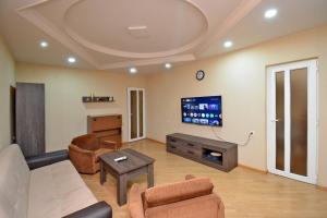 a living room with a couch and a tv at The Best Apartment in Yerevan