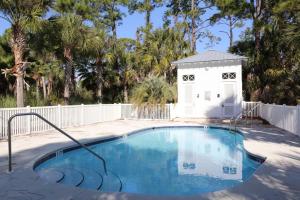 a small swimming pool with a dog house at Rehoboth Cottage by Pristine Properties Vacation Rentals in Indian Pass