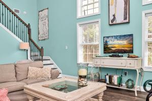 a living room with a couch and a table at Rehoboth Cottage by Pristine Properties Vacation Rentals in Indian Pass