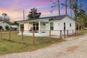 a small white house with a fence around it at The Surf Ranch by Pristine Properties Vacation Rentals in Port Saint Joe