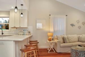 a kitchen and a living room with a couch at The Surf Ranch by Pristine Properties Vacation Rentals in Port Saint Joe +44 photos