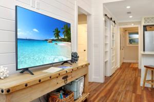 a flat screen tv sitting on top of a fireplace in a living room at The Surf Ranch by Pristine Properties Vacation Rentals in Port Saint Joe