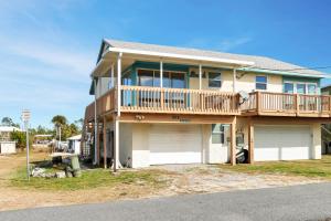 a large house with a deck and a garage at Sea Shell by Pristine Properties Vacation Rentals in Mexico Beach