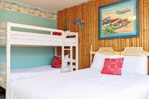 two bunk beds in a room with wooden walls at Sea Shell by Pristine Properties Vacation Rentals in Mexico Beach