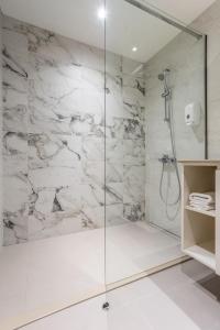 a bathroom with a shower with a glass door at Belgrade Waterfront Sole in Sajmište +12 photos