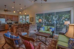 a living room with a couch and a table at Camp Palms @ Indian Pass by Pristine Properties Vacation Rentals in Indian Pass