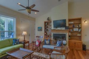 a living room with a couch and a fireplace at Camp Palms @ Indian Pass by Pristine Properties Vacation Rentals in Indian Pass