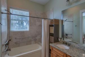 a bathroom with a tub and a sink and a shower at Camp Palms @ Indian Pass by Pristine Properties Vacation Rentals in Indian Pass +25 photos