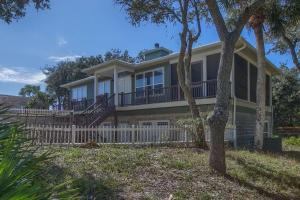 a large house with a white fence in front of it at Camp Palms @ Indian Pass by Pristine Properties Vacation Rentals in Indian Pass