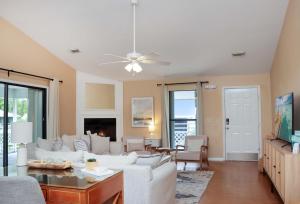 a living room with a couch and a table at Woofs and Waves by Pristine Properties Vacation Rentals in Cape San Blas