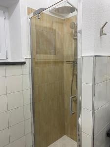 a shower with a glass door in a bathroom at MARIMA' la Casa Vacanze - Holidays Suites in Maratea +18 photos