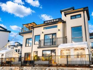 a white building with a fence in front of it at Chuncheon Kerensia Pension in Chuncheon +268 photos
