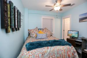 a bedroom with a bed and a desk and a ceiling fan at Beach View Lower by Pristine Properties Vacation Rentals in Mexico Beach