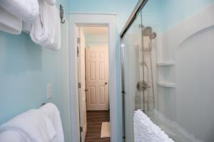a bathroom with a shower and a glass door at Beach View Lower by Pristine Properties Vacation Rentals in Mexico Beach +38 photos