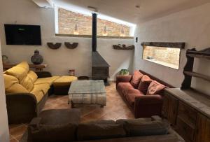 a living room with couches and a fire place at Masoala Forest in Piera