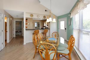 a dining room and kitchen with a table and chairs at DeLight House by Pristine Properties Vacation Rentals in Indian Pass