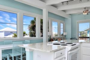 a kitchen with blue walls and a counter with a stove at Beach View Upper by Pristine Properties Vacation Rentals in Mexico Beach