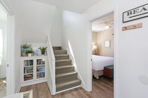 a staircase leading to a bedroom with a bed at Narrow Escape by Pristine Properties Vacation Rentals in Cape San Blas