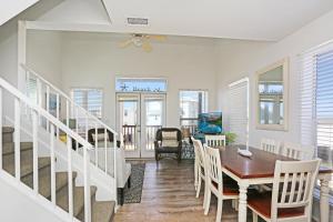 a dining room and living room with a table and chairs at Narrow Escape by Pristine Properties Vacation Rentals in Cape San Blas