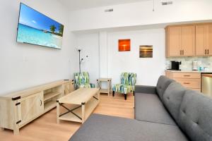 a living room with a couch and a table at Dolphin Daze Hideaway by Pristine Properties Vacation Rentals in Saint Joe Beach