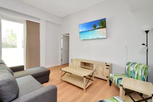 a living room with a couch and a table at Dolphin Daze Hideaway by Pristine Properties Vacation Rentals in Saint Joe Beach
