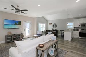 a living room with a white couch and a table at Second Chance by Pristine Properties Vacation Rentals in Mexico Beach