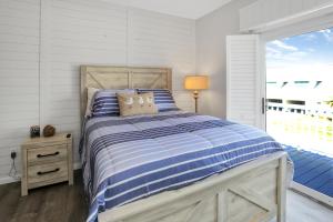 a bedroom with a bed and a large window at Set Sail at 5 by Pristine Properties Vacation Rentals in Mexico Beach