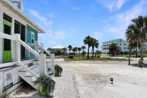 a house on the beach with palm trees and a building at Second Chance by Pristine Properties Vacation Rentals in Mexico Beach