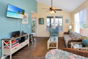 a living room with a couch and a tv at Sweet Destiny by Pristine Properties Vacation Rentals in Indian Pass