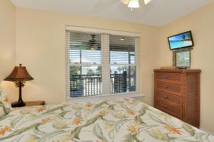 a bedroom with a bed and a dresser and a window at Sweet Destiny by Pristine Properties Vacation Rentals in Indian Pass