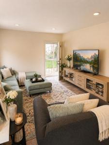 a living room with a couch and a flat screen tv at Beach Condo in Dana Point
