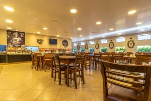 a dining room with tables and chairs in a restaurant at O Recanto Pousada in Serra Negra