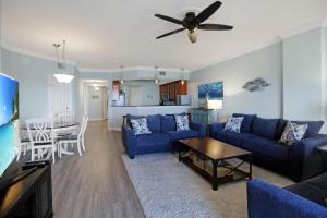 a living room with a blue couch and a table at Paradise Shores 302 Serenity Shores by Pristine Properties Vacation Rentals in Mexico Beach