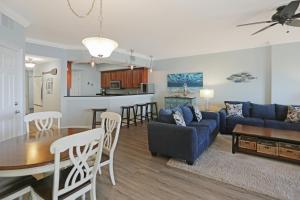 a living room and kitchen with a couch and a table at Paradise Shores 302 Serenity Shores by Pristine Properties Vacation Rentals in Mexico Beach