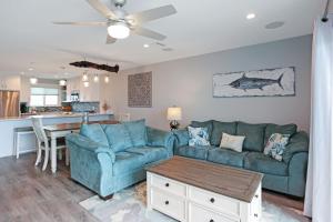 a living room with a couch and a table at Sharla's Sunrise by Pristine Properties Vacation Rentals in Indian Pass