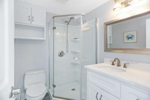 a bathroom with a shower and a toilet and a sink at Sharla's Sunrise by Pristine Properties Vacation Rentals in Indian Pass +35 photos
