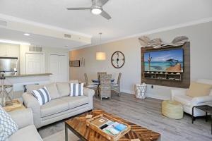 a living room with a couch and a table at Summerhouse 209 by Pristine Properties Vacation Rentals in Mexico Beach