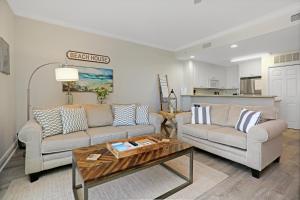 a living room with two couches and a coffee table at Summerhouse 209 by Pristine Properties Vacation Rentals in Mexico Beach
