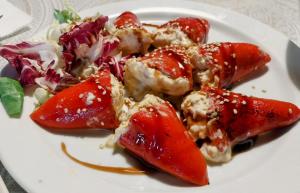 a plate of food with strawberries and a salad at Hotel Rural Inz-Almaraz in Jimera de Líbar