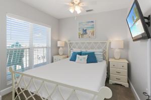 a bedroom with a white bed and a window at Surfside 15 - Beachtime by Pristine Properties Vacation Rentals in Mexico Beach +52 photos