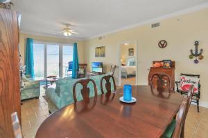 a dining room and living room with a table at Summerhouse 203 by Pristine Properties Vacation Rentals in Mexico Beach
