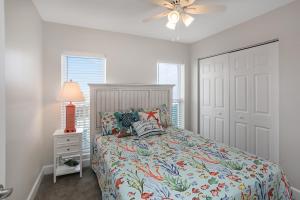 a bedroom with a bed and a ceiling fan at Surfside 17 by Pristine Properties Vacation Rentals in Mexico Beach