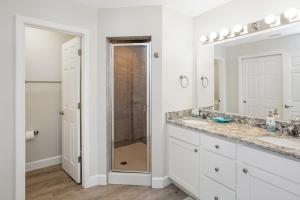 a bathroom with two sinks and a shower at Surfside 17 by Pristine Properties Vacation Rentals in Mexico Beach +39 photos