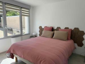 a bedroom with a large bed and a window at La Bergerie 3 in Neufchâteau