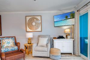 a living room with a chair and a tv on the wall at Their Inheritance by Pristine Properties Vacation Rentals in Indian Pass