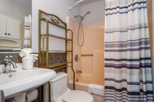 a bathroom with a sink and a toilet and a shower at Their Inheritance by Pristine Properties Vacation Rentals in Indian Pass +48 photos