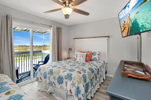 a bedroom with a bed and a balcony at Their Inheritance by Pristine Properties Vacation Rentals in Indian Pass