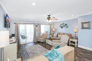 a living room with a couch and a table at Beach Therapy by Pristine Properties Vacation Rentals in Cape San Blas