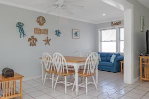 a dining room and living room with a table and chairs at Whataday by Pristine Properties Vacation Rentals in Cape San Blas