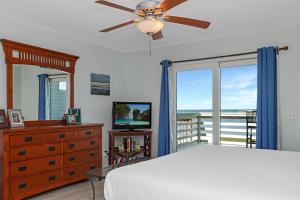 a bedroom with a bed and a dresser and a window at Whataday by Pristine Properties Vacation Rentals in Cape San Blas